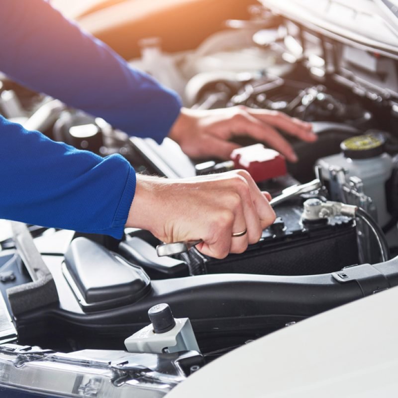 Hands,Of,Car,Mechanic,With,Wrench,In,Garage